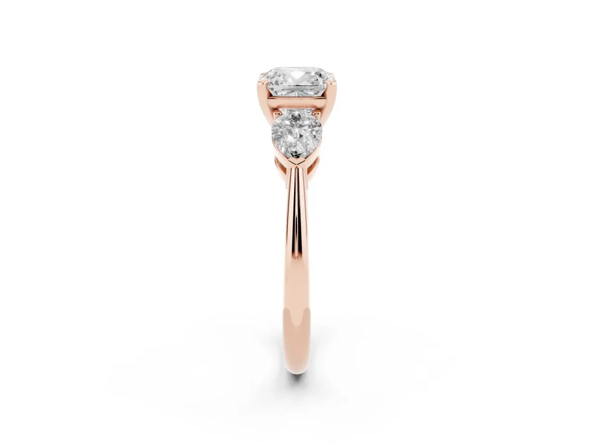 Three-Stone Cushion Cut Diamond Ring with Pear Side Stones and Four-Prong Setting Rose gold