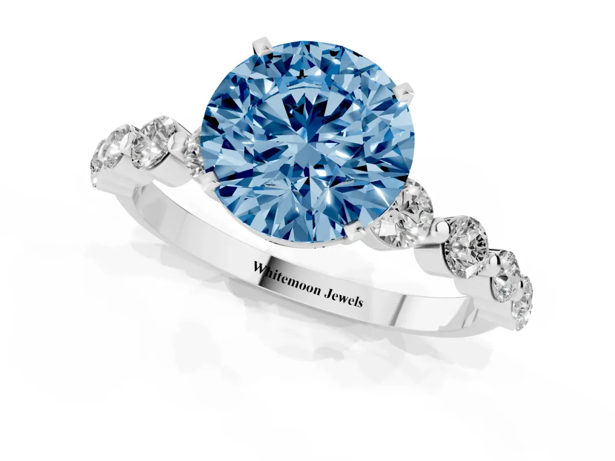 Fancy Blue Round Cut Solitaire Diamond Ring with Pave Band and Four-Prong Setting Silver