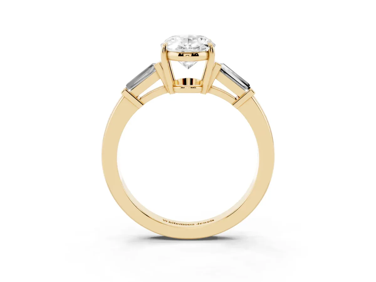 Oval Cut Diamond Three-Stone Ring with Tapered Baguette Side Stones and Prong Setting Yellow gold