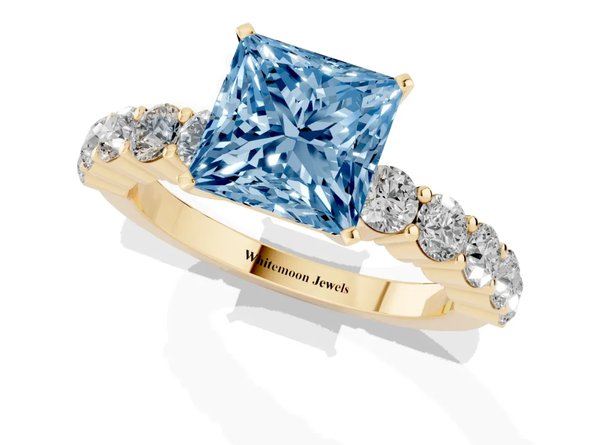 Fancy Blue Princess Cut Diamond Solitaire Ring with Shared Prong Round Side Stones Yellow gold