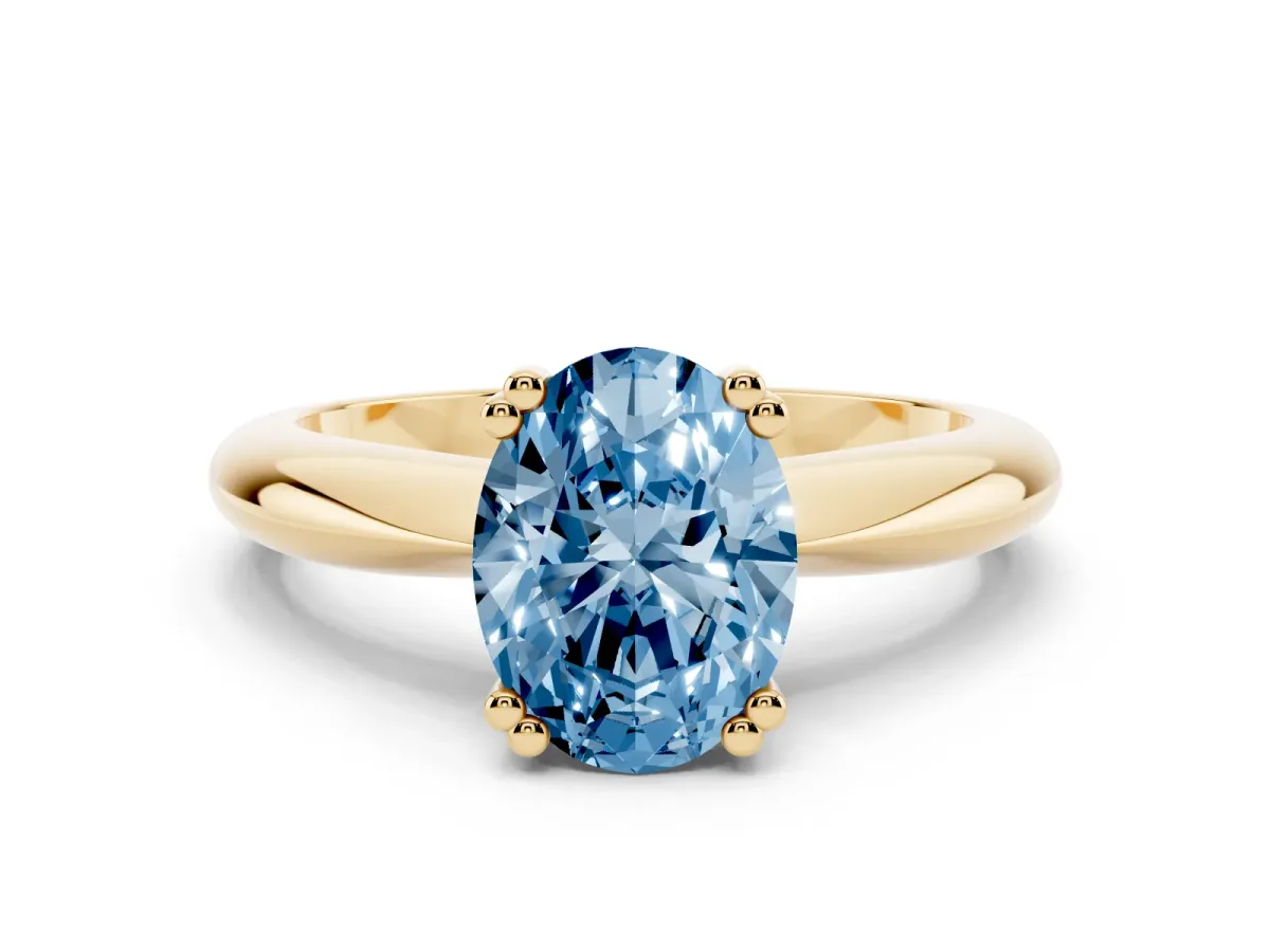 Fancy Blue Oval Cut Cut Solitaire Engagement Ring with Tapered Band and Four-Prong Setting Yellow gold