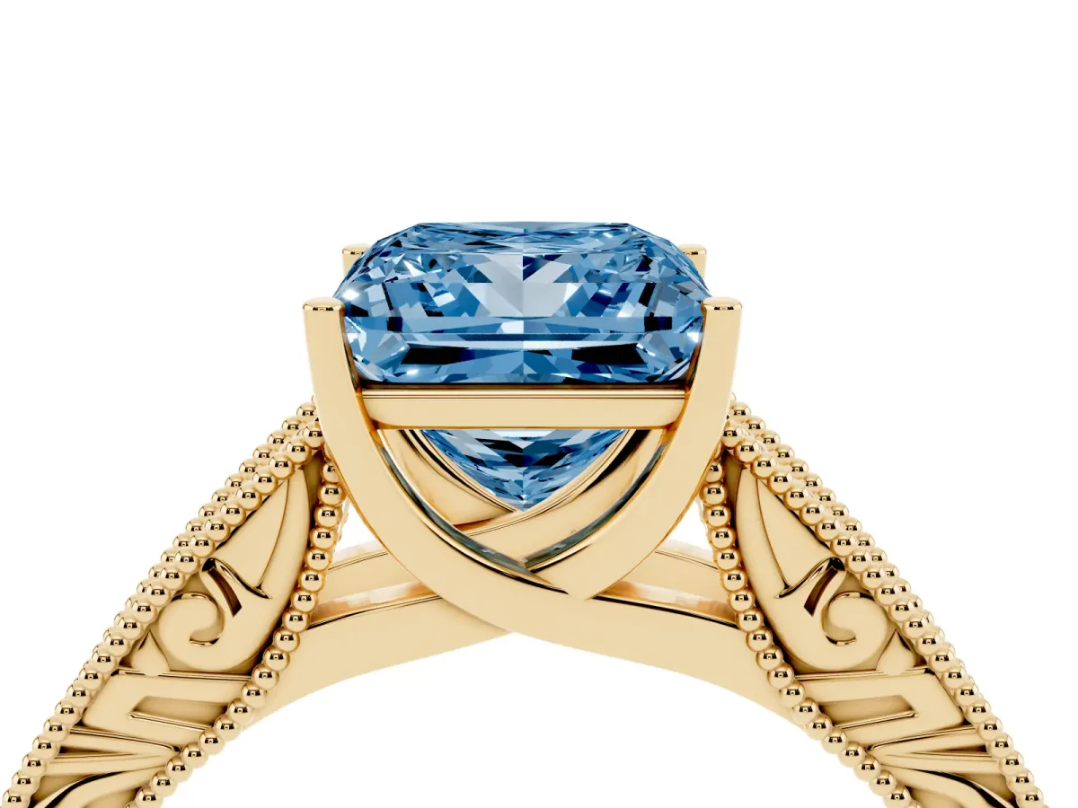Fancy Blue Princess Cut Diamond Solitaire Ring with Engraved Band and Four-Prong Setting Yellow gold