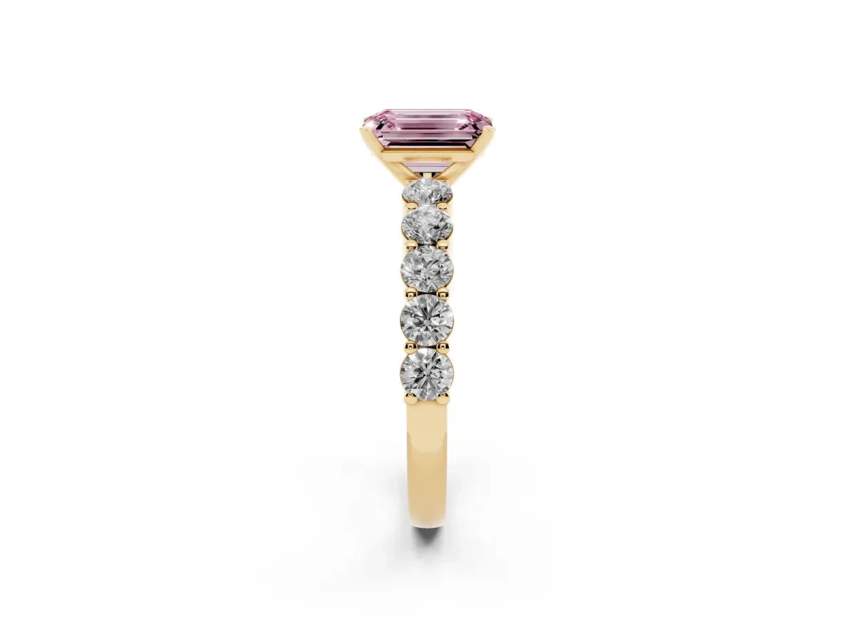 Fancy Pink Emerald Cut Diamond Solitaire Ring with Shared Prong Round Side Stones Yellow gold