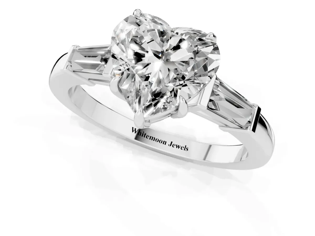 Heart Cut Diamond Three-Stone Ring with Tapered Baguette Side Stones and Prong Setting Platinum