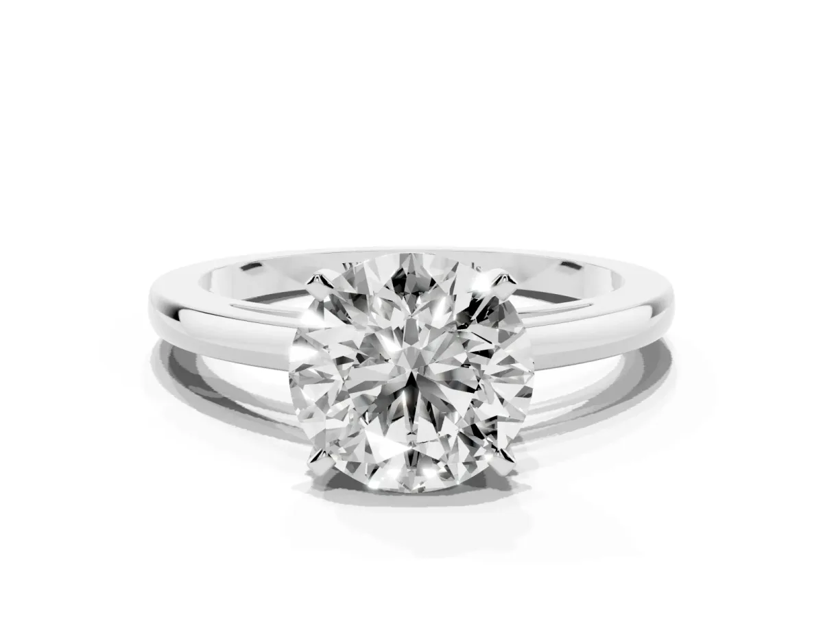 Round Cut Solitaire Diamond Engagement Ring with Four-Prong Setting on a Classic Band Silver