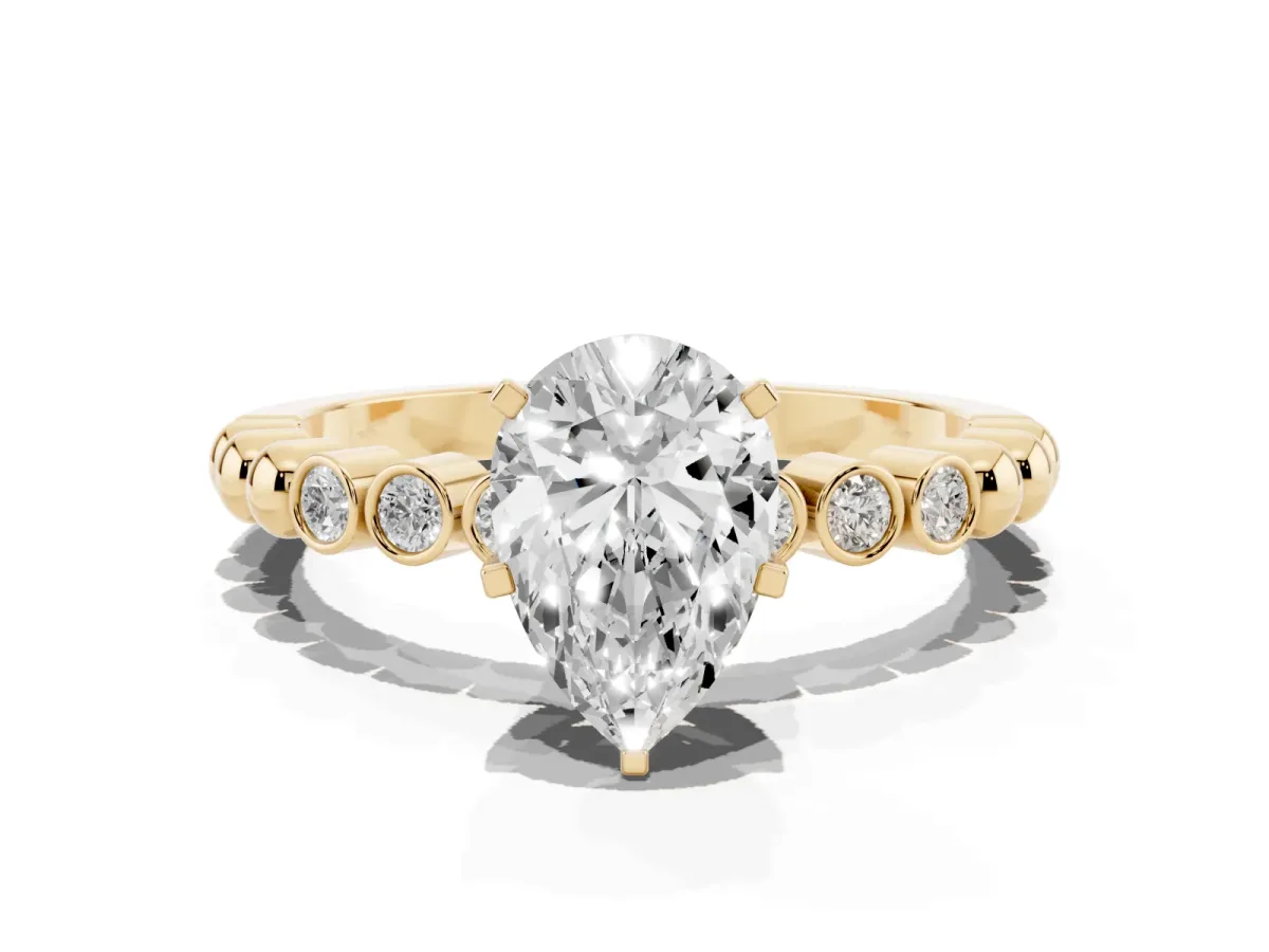 Pear Cut Solitaire Bezel Accent Diamond Engagement Ring with Beaded Band and Four-Prong Setting Yellow gold