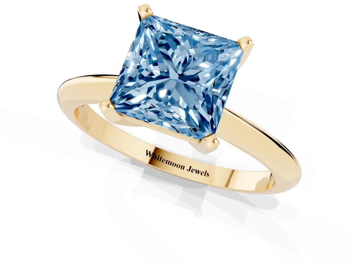 Fancy Blue Princess Cut Cut Solitaire Ring with Four-Prong Setting on a Classic Band Yellow gold