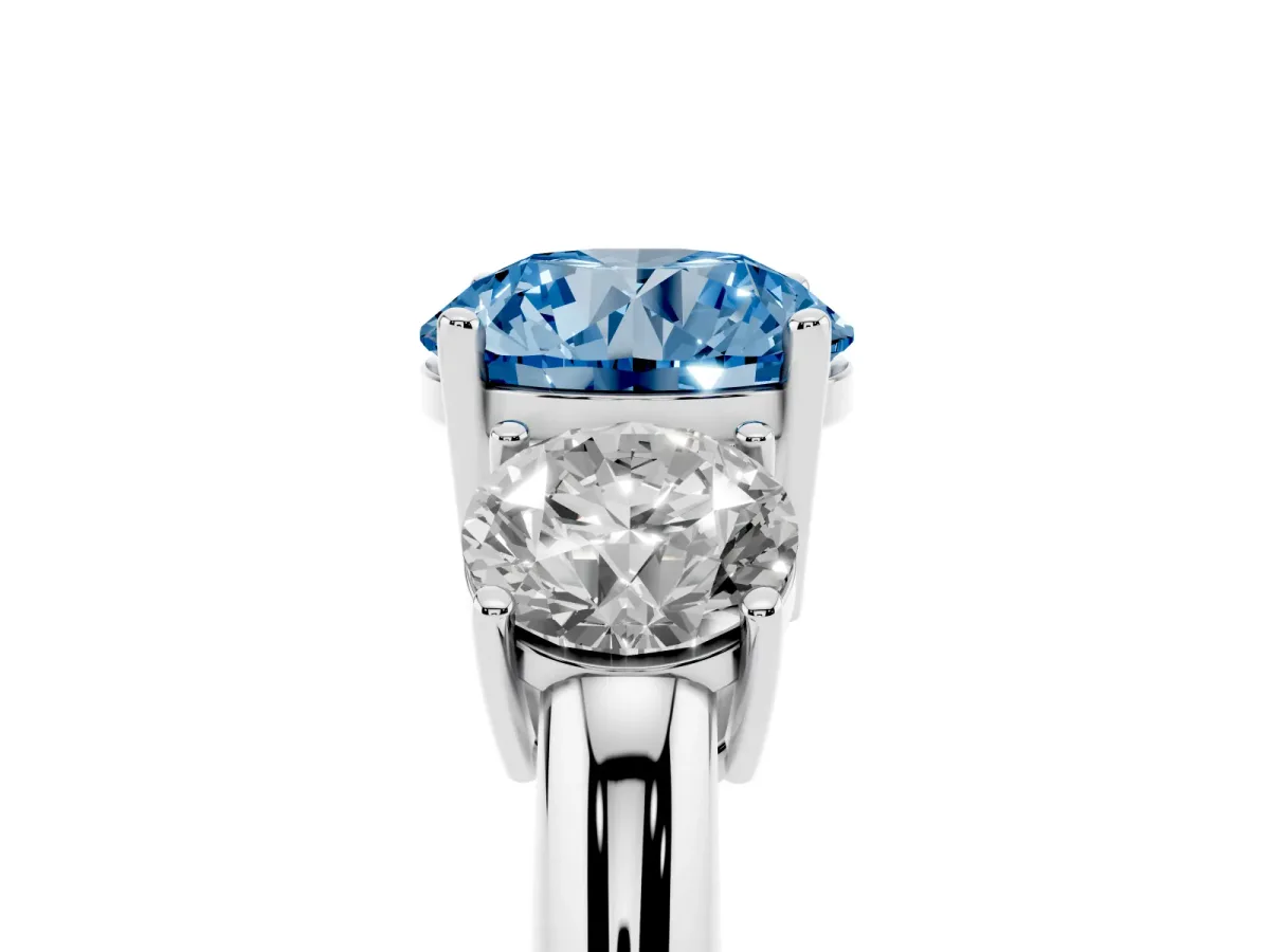 Fancy Blue Three-Stone Round Cut Cut Diamond Engagement Ring with Prong Setting on a White Gold Band Platinum