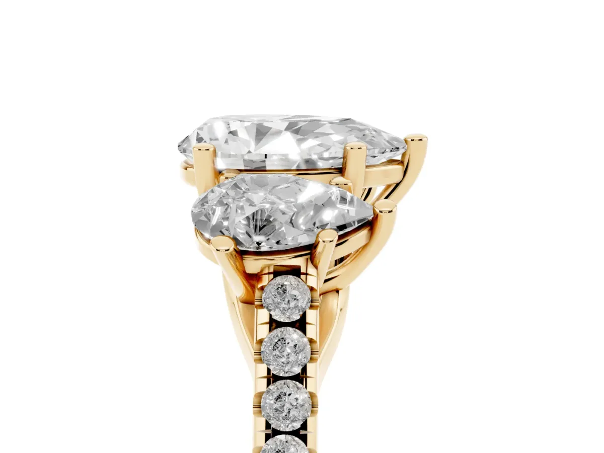 Three-Stone Pear Cut Diamond Ring with Round Pavé Band and Prong Setting Yellow gold