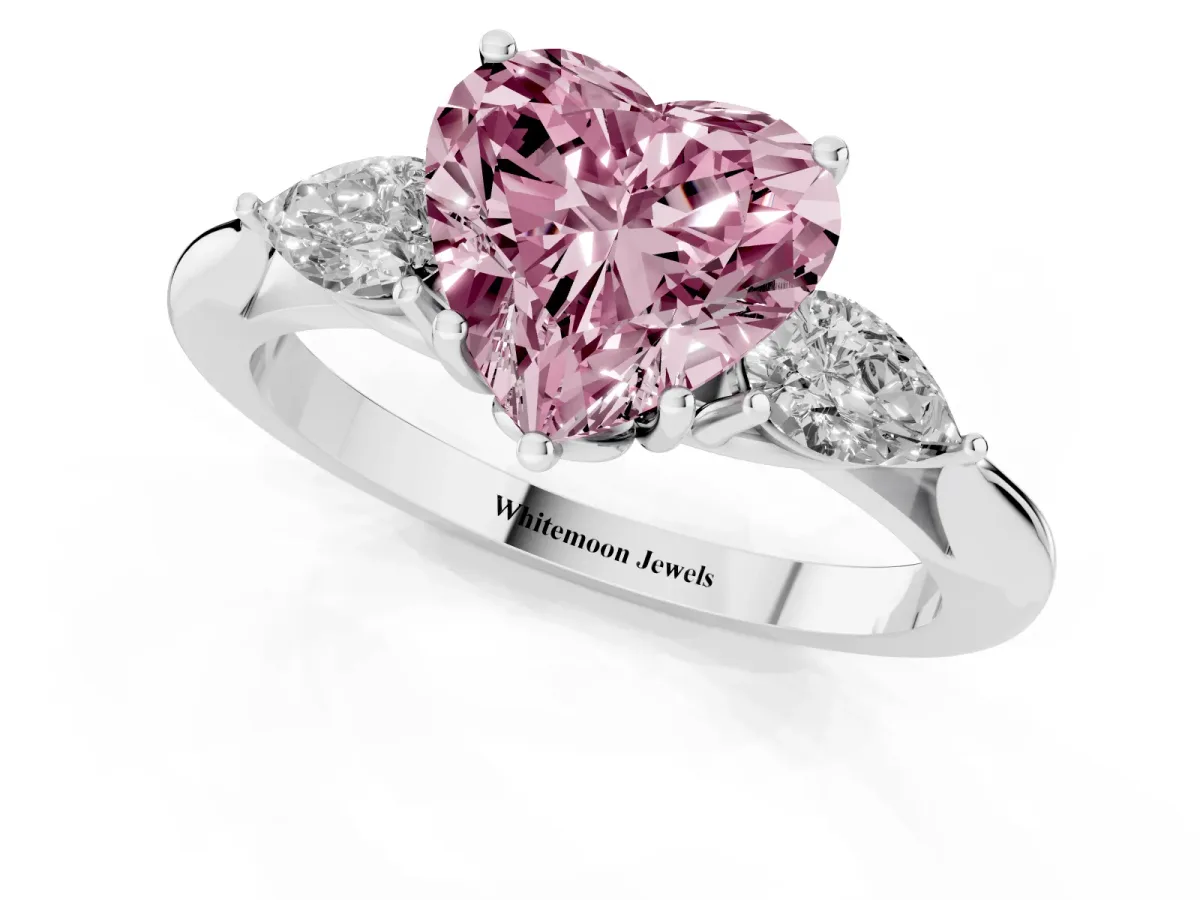 Fancy Pink Three-Stone Heart Cut Brilliant Diamond Solitaire Ring with Tapered Band and Four-Prong Setting White gold