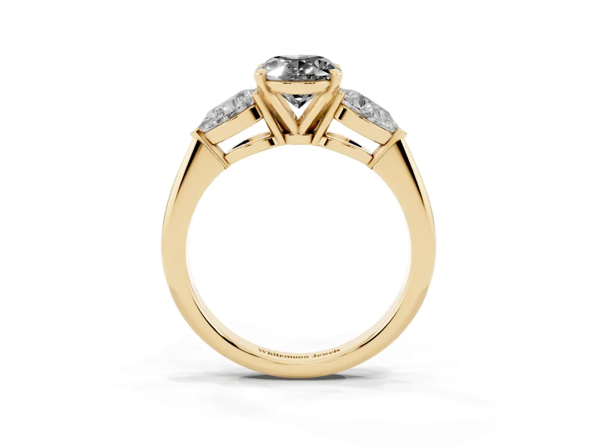 Fancy Black Three-Stone Oval Cut Diamond Ring with Pear Side Stones and Four-Prong Setting Yellow gold