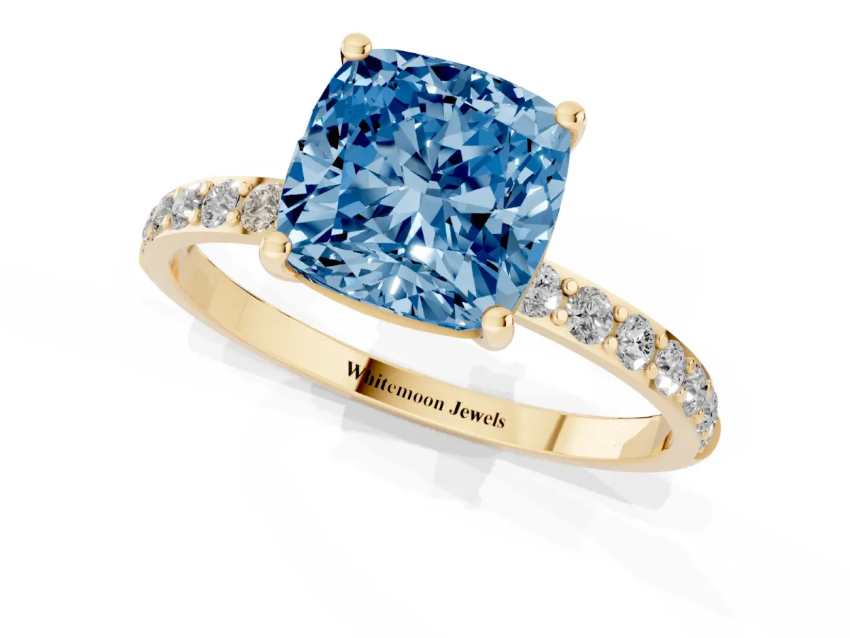 Fancy Blue Cushion Cut Diamond Solitaire Ring with Round Pavé Shoulders and Prong Setting Yellow gold