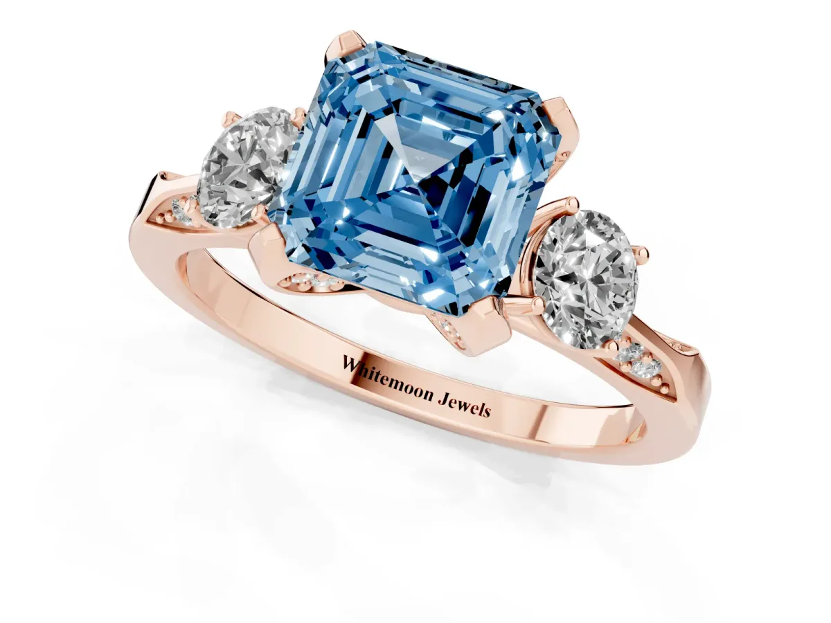 Fancy Blue Asscher Cut Brilliant Three-Stone Diamond Ring with Pavé Band and Four-Prong Setting Rose gold