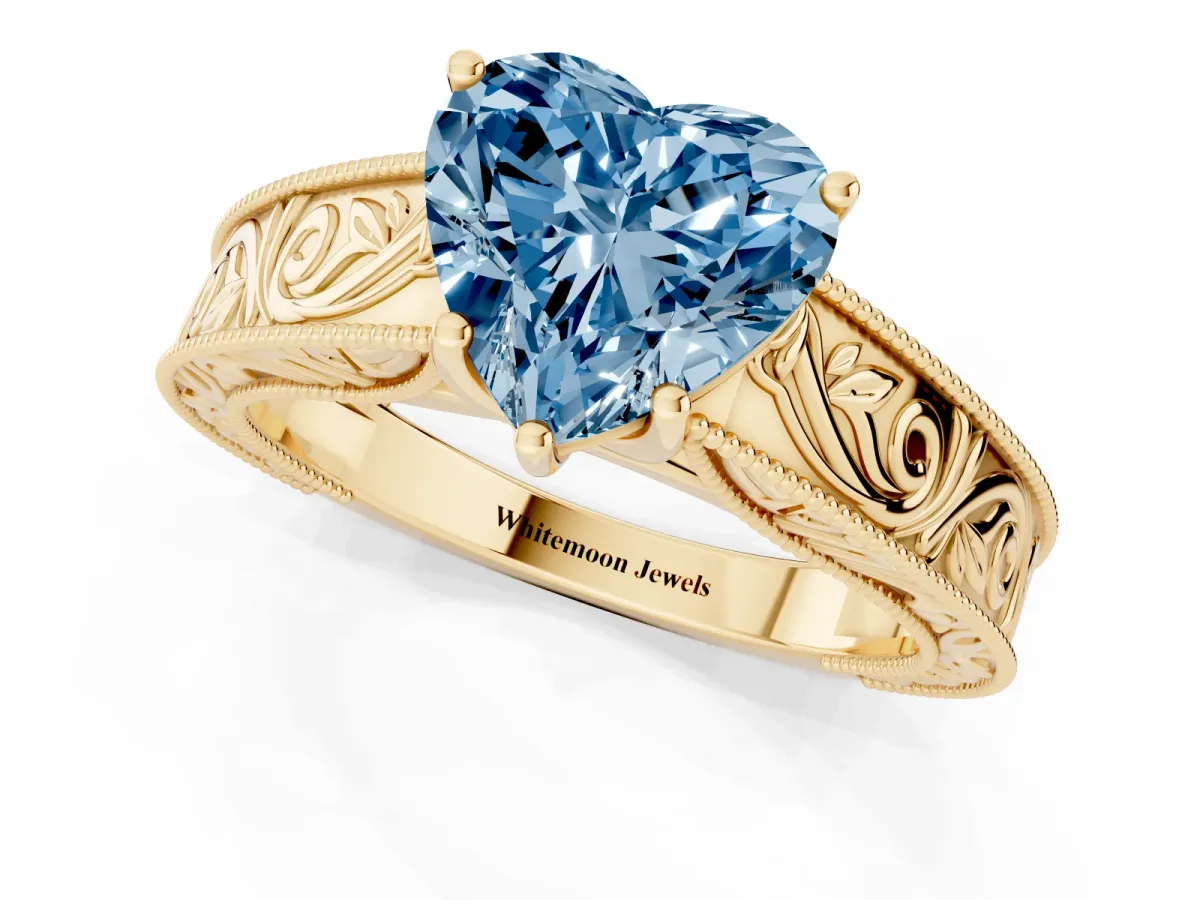 Fancy Blue Heart Cut Diamond Solitaire Ring with Engraved Band and Four-Prong Setting Yellow gold