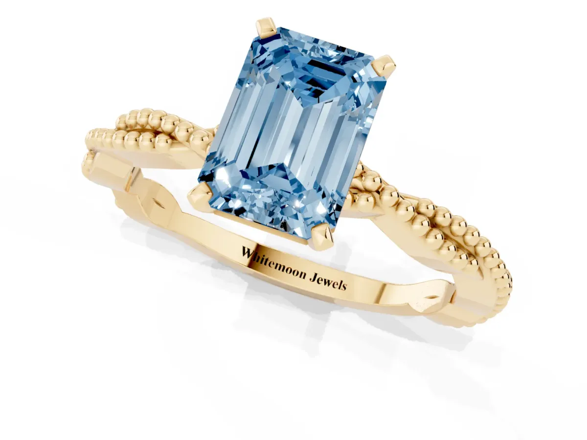 Fancy Blue Emerald Cut Solitaire Twisted Band with Bead Prong Setting Yellow gold
