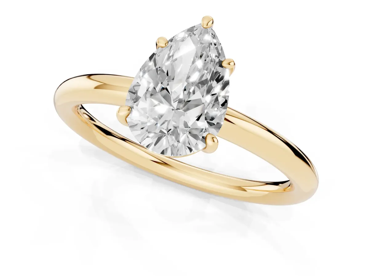 Pear Cut Solitaire Diamond Ring with Four-Prong Setting on a Plain Band Yellow gold
