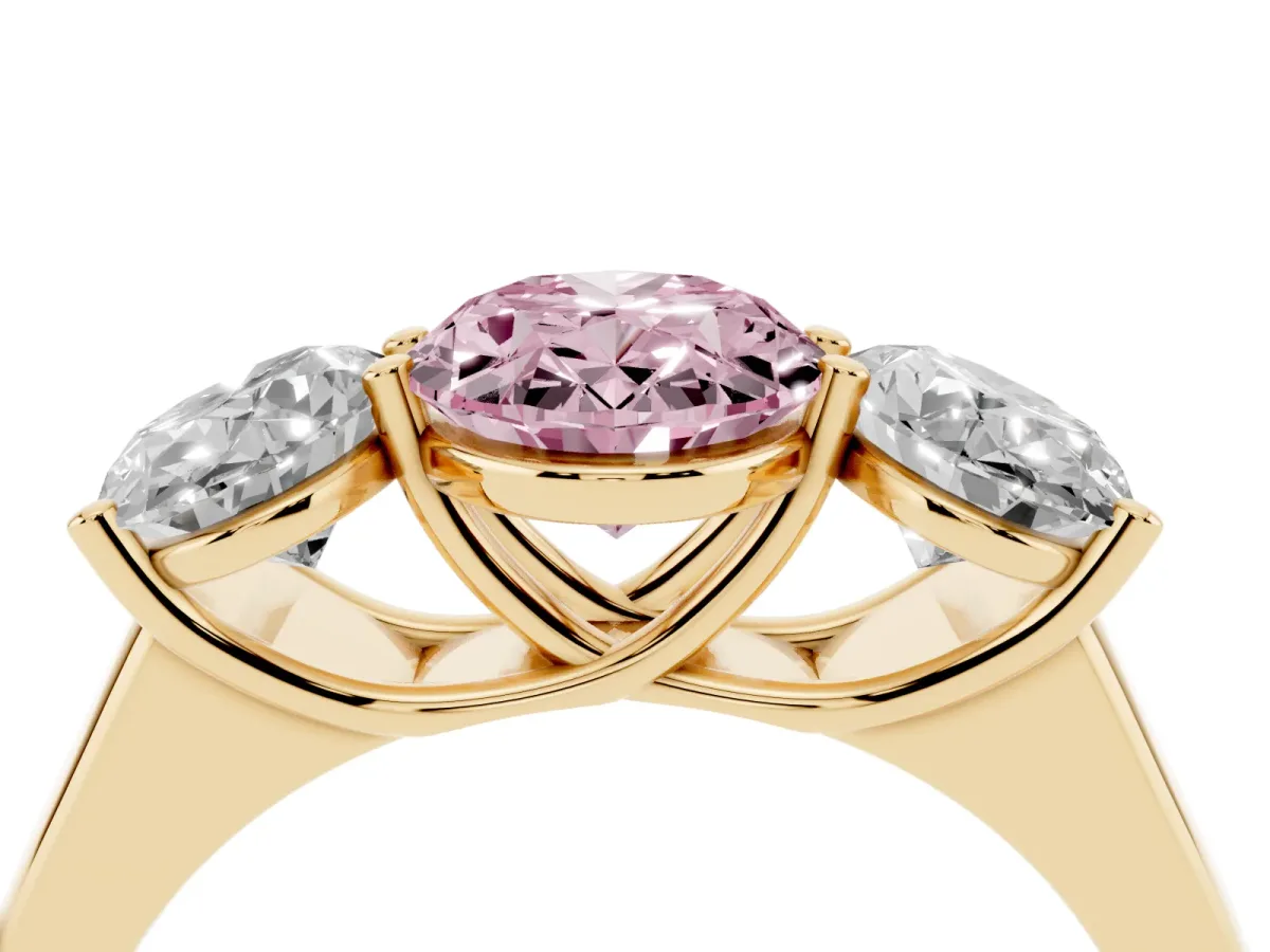 Fancy Pink Oval Cut Three-Stone Diamond Ring with Prong Setting on a Classic Band Yellow gold