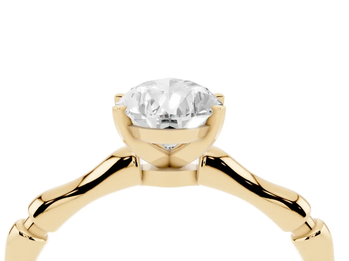 Pear Cut Solitaire Diamond Ring with Bamboo Band and Four-Prong Setting Yellow gold