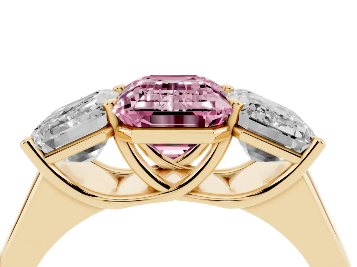 Fancy Pink Emerald Cut Three-Stone Diamond Ring with Prong Setting on a Classic Band Yellow gold