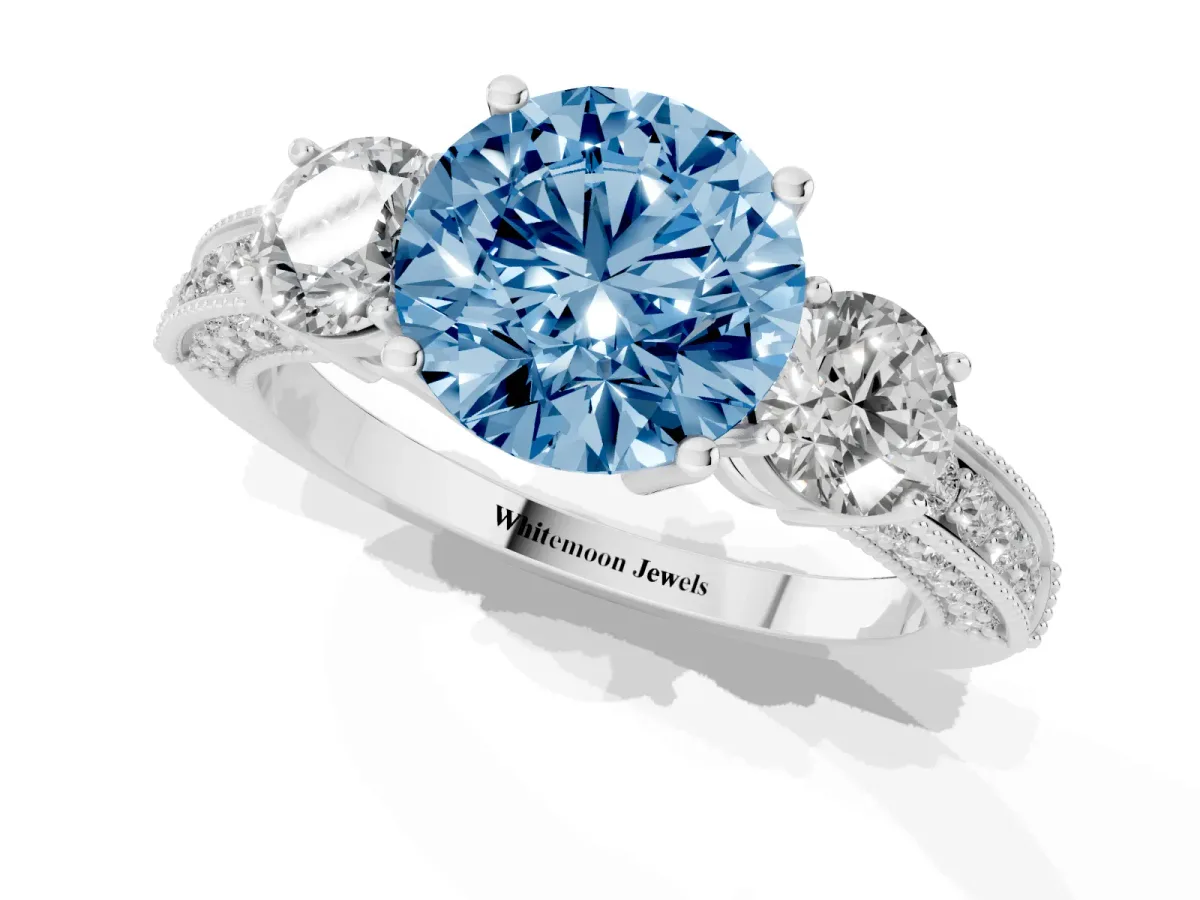 Fancy Blue Round Cut Three-Stone Diamond Ring with Pavé Band and Four-Prong Setting Silver