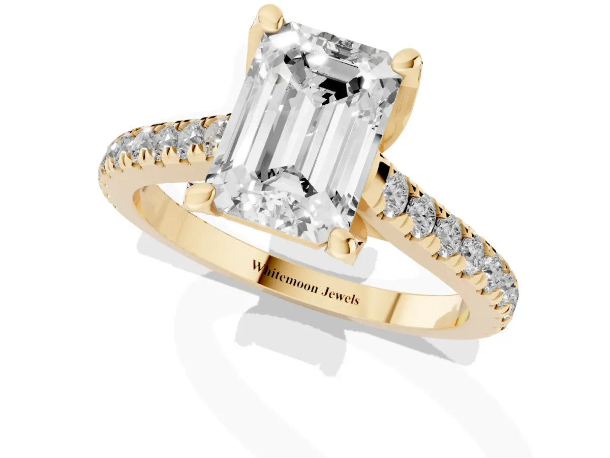 Emerald Cut Brilliant Diamond Solitaire with Pavé Band and Four-Prong Setting Yellow gold