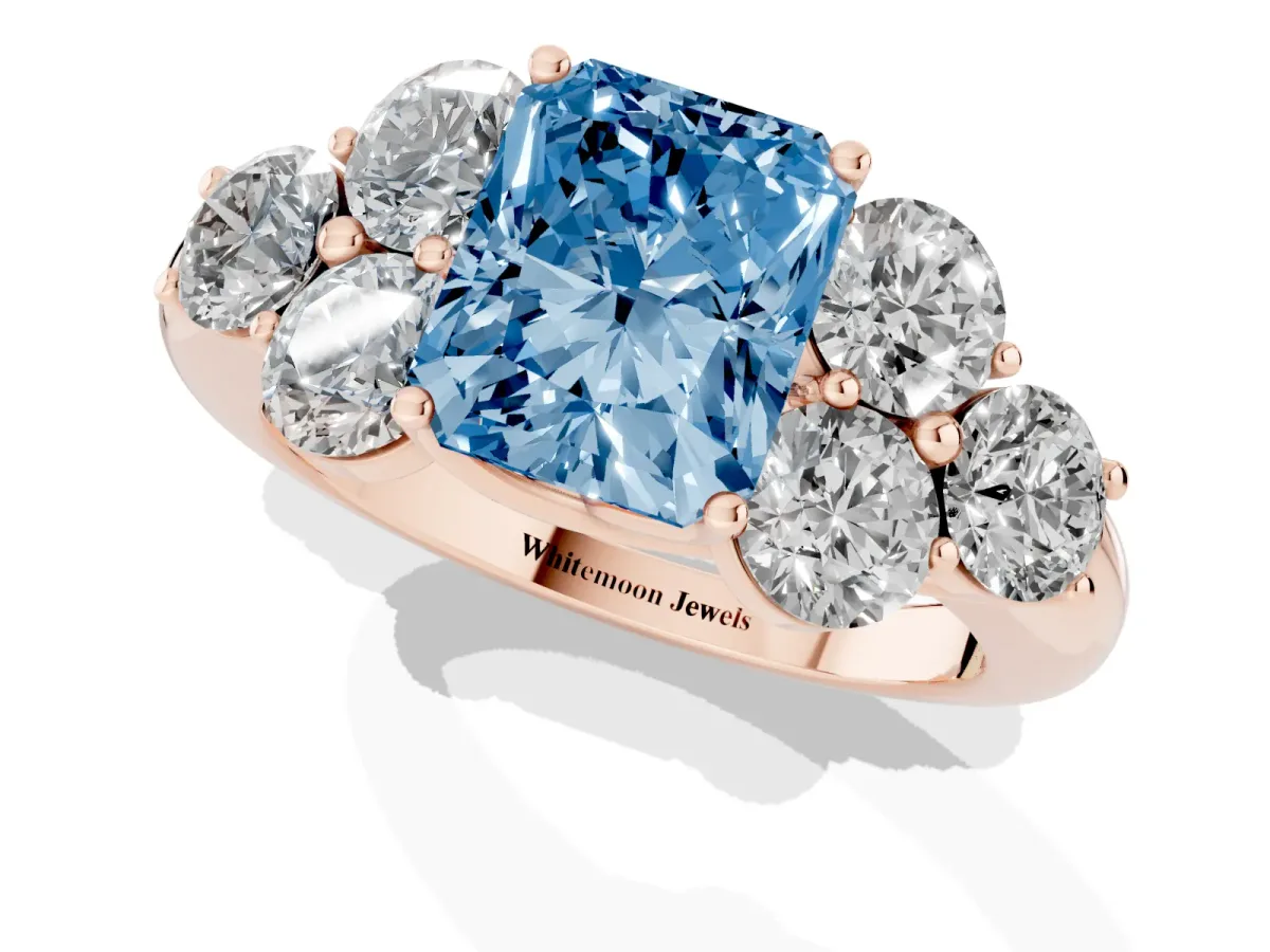 Fancy Blue Radiant Cut Cut Diamond Cluster Ring with Round Accent Stones and Prong Setting on a Classic Band Rose gold