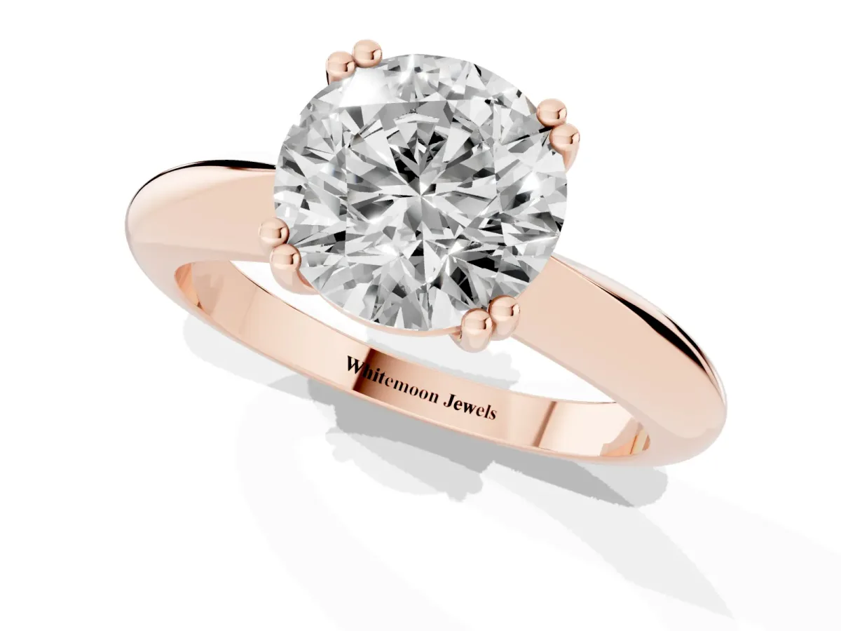 Round Cut Cut Solitaire Engagement Ring with Tapered Band and Four-Prong Setting Rose gold