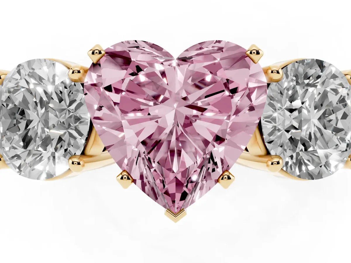 Fancy Pink Three-Stone Heart Cut Diamond Ring with Round Side Stones, Classic Band, and Four-Prong Setting Yellow gold