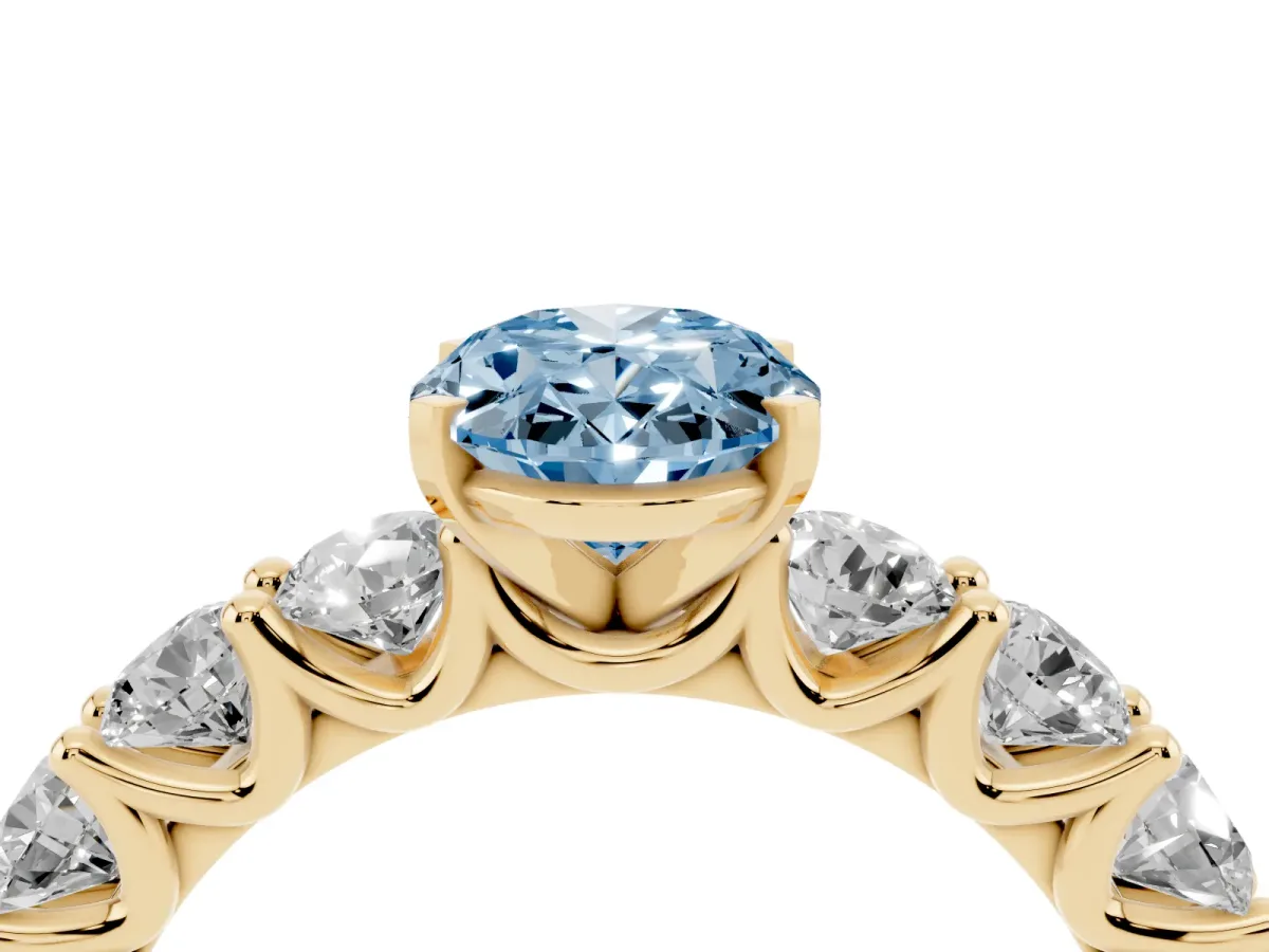 Fancy Blue Oval Cut Diamond Prong Setting with Side Stones on a Pave Band Yellow gold