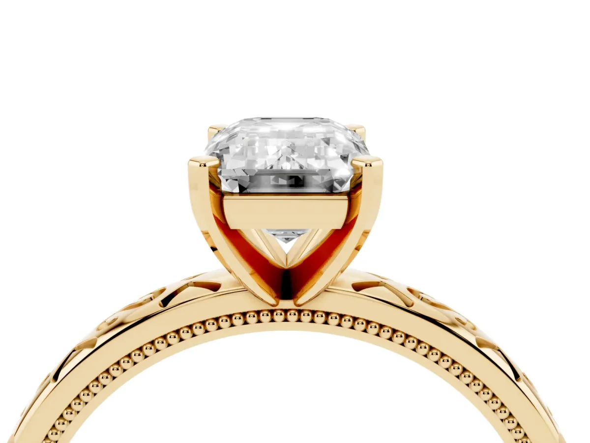 Emerald Cut Solitaire Engagement Ring with Scrollwork Band and Four-Prong Setting Yellow gold