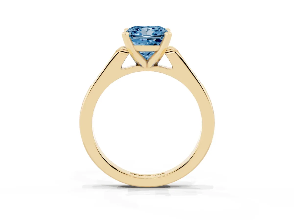 Fancy Blue Princess Cut Diamond Solitaire Ring with Channel Set Round Band and Prong Setting Yellow gold