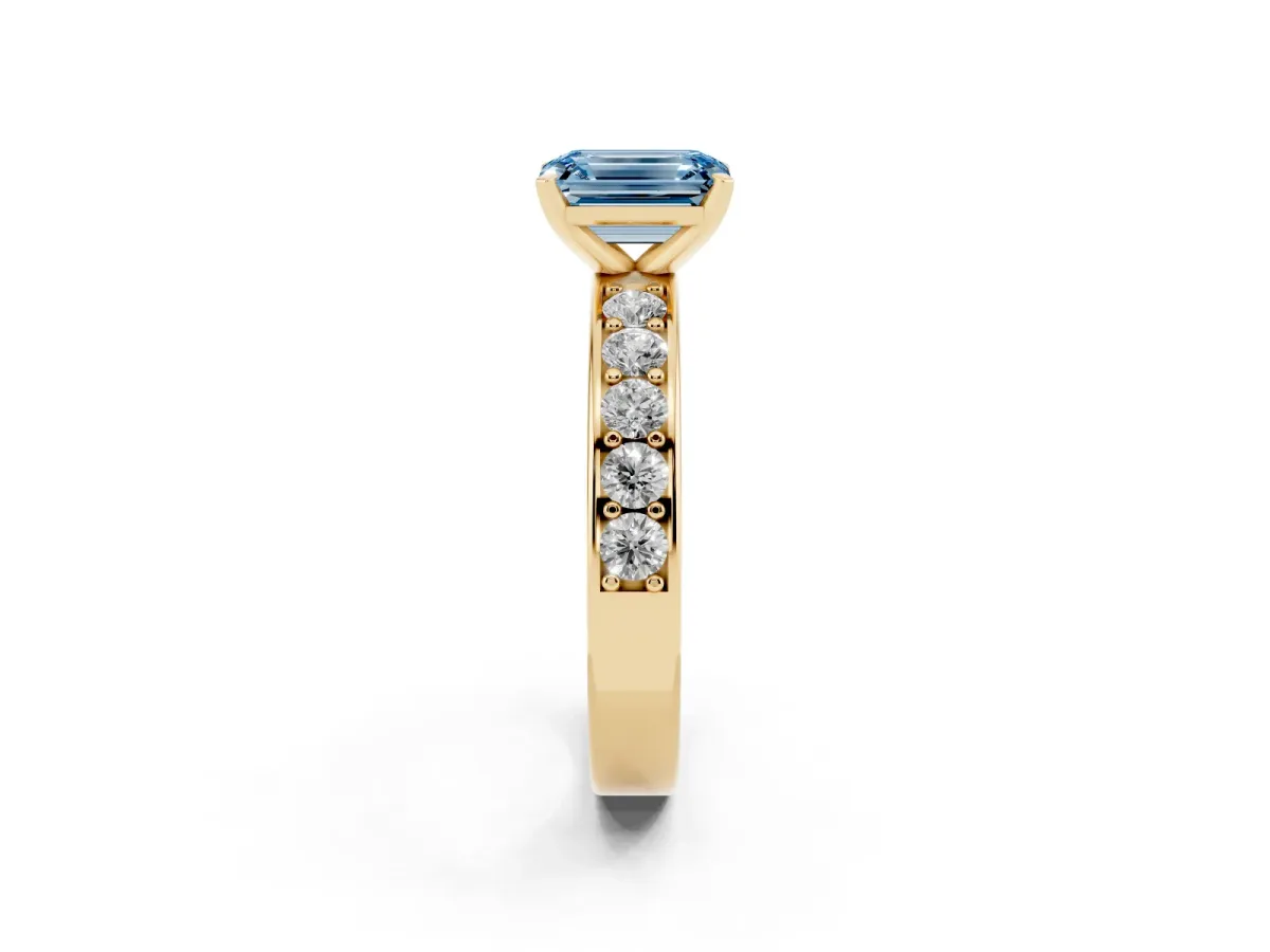 Fancy Blue Emerald Cut Diamond Engagement Ring with Channel Set Round Band and Prong Setting Yellow gold
