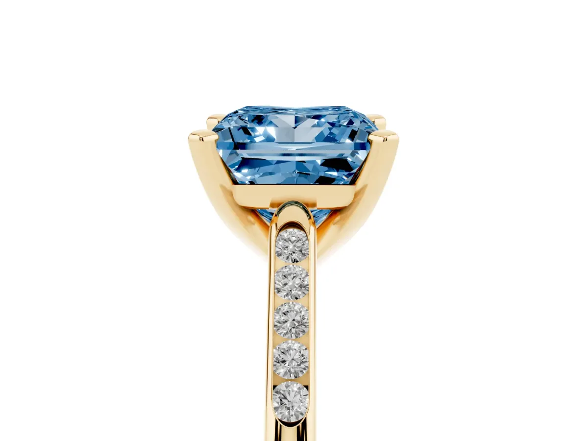 Fancy Blue Princess Cut Diamond Solitaire Ring with Channel Set Round Band and Prong Setting Yellow gold