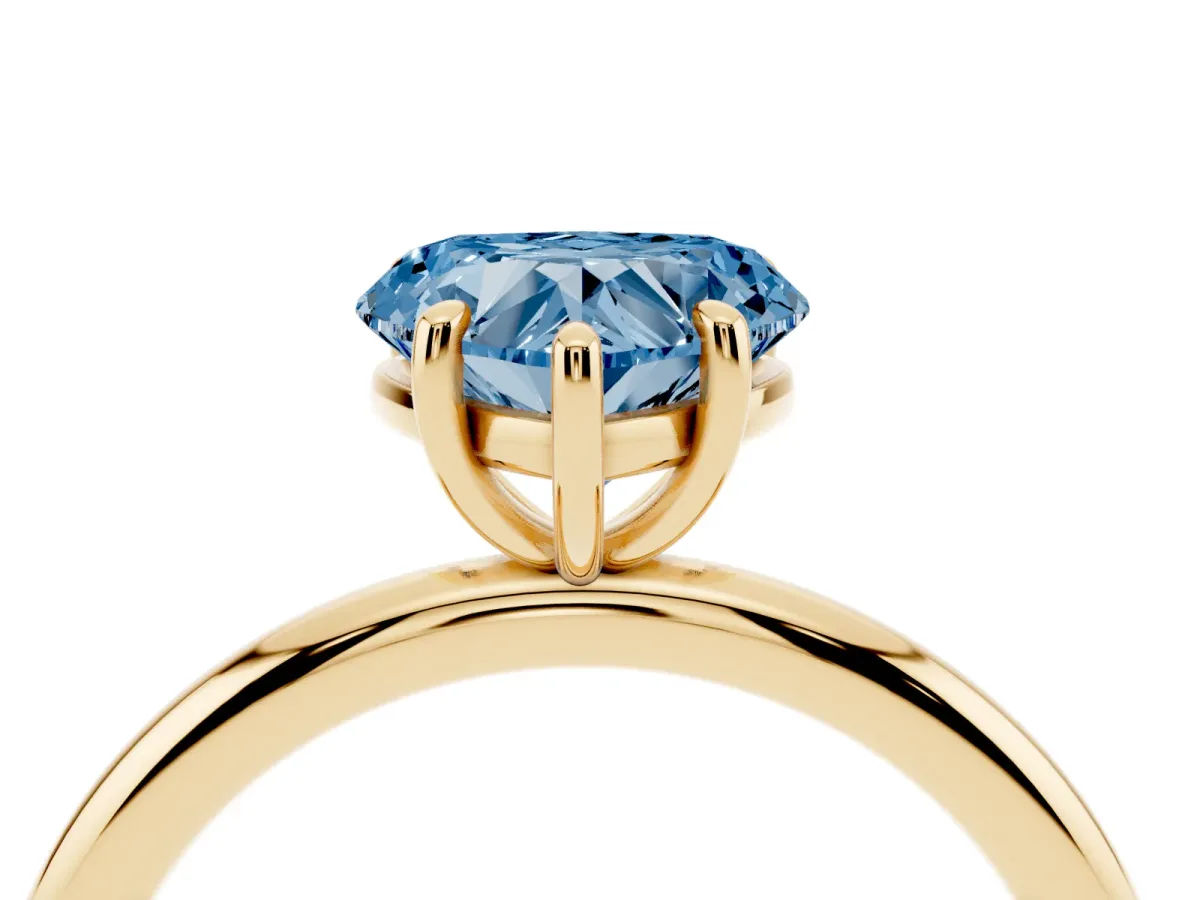 Fancy Blue Heart Cut Solitaire Diamond Ring with Four-Prong Setting on a Plain Band Yellow gold