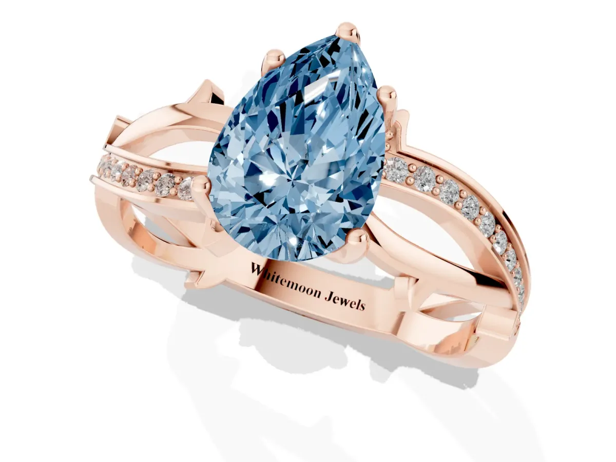 Fancy Blue Pear Cut Solitaire Twist Band with Pavé Accents and Four-Prong Setting Rose gold