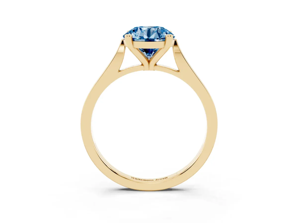 Fancy Blue Round Cut Solitaire Diamond Ring with Four-Prong Setting and Tapered Band Yellow gold