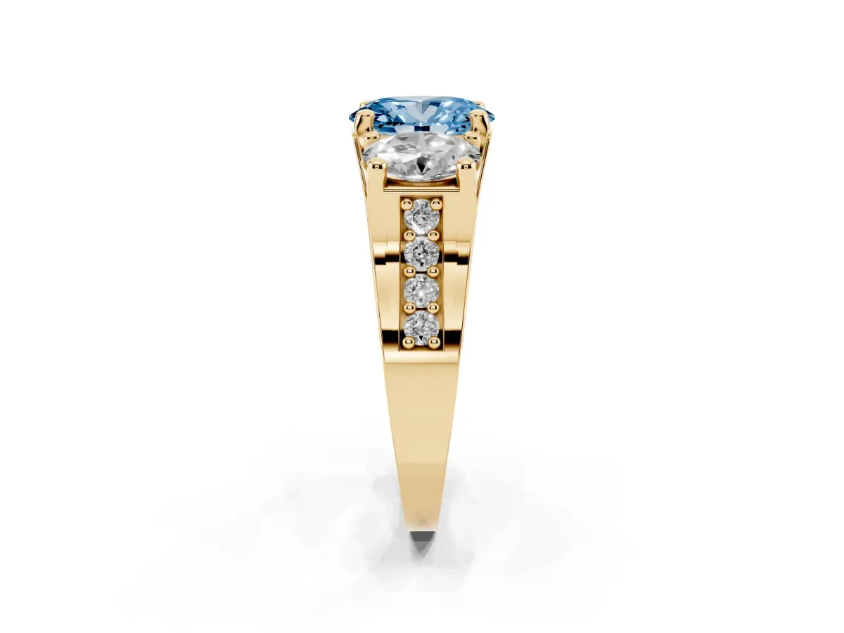 Fancy Blue Oval Cut Diamond Three-Stone Ring with Channel Set Band and Four-Prong Setting Yellow gold