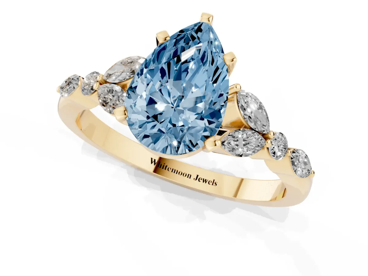 Fancy Blue Pear Cut Diamond Solitaire Ring with Side Stones and Four-Prong Setting Yellow gold