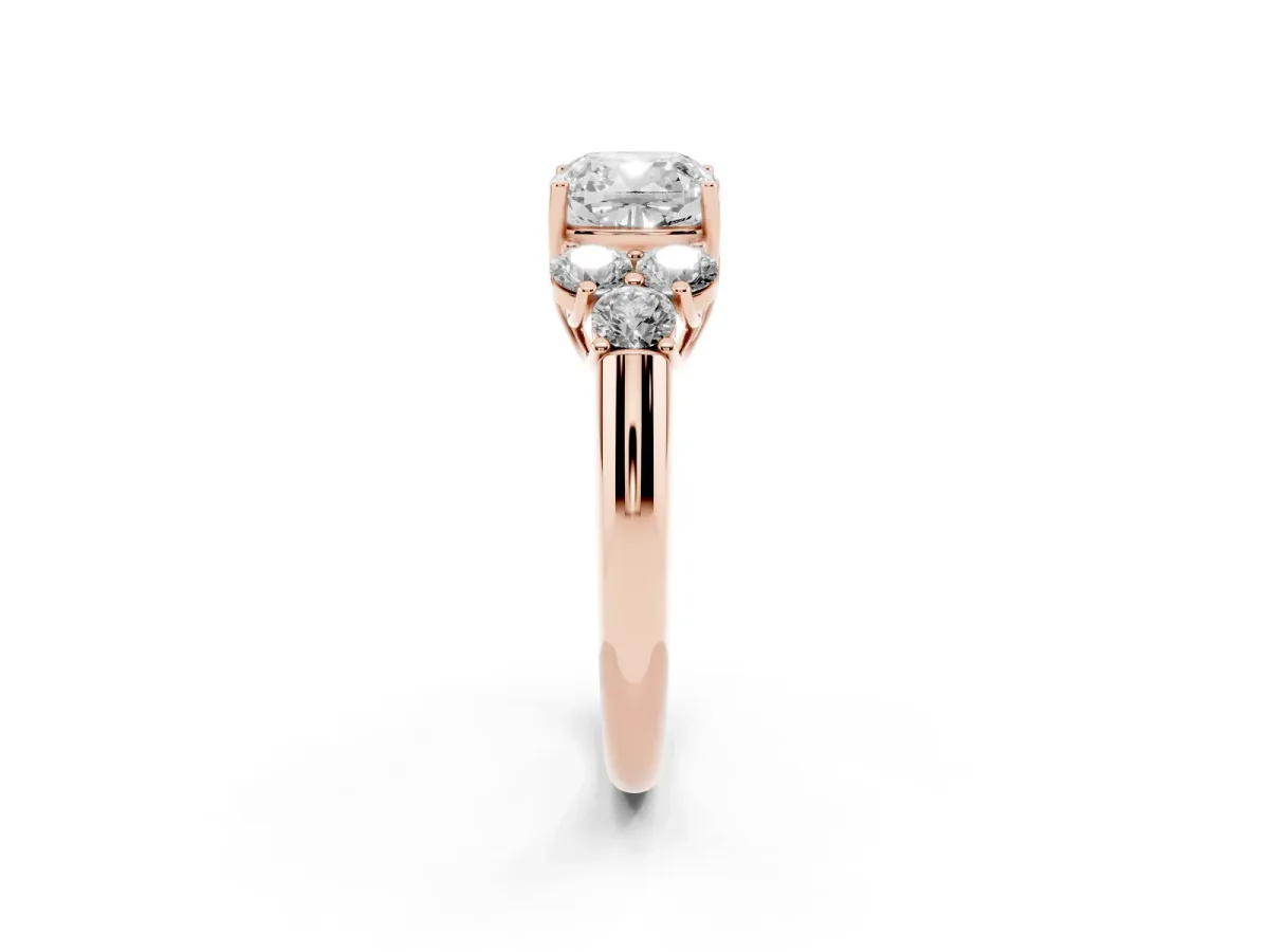 Cushion Cut Cut Diamond Cluster Ring with Round Accent Stones and Prong Setting on a Classic Band Rose gold