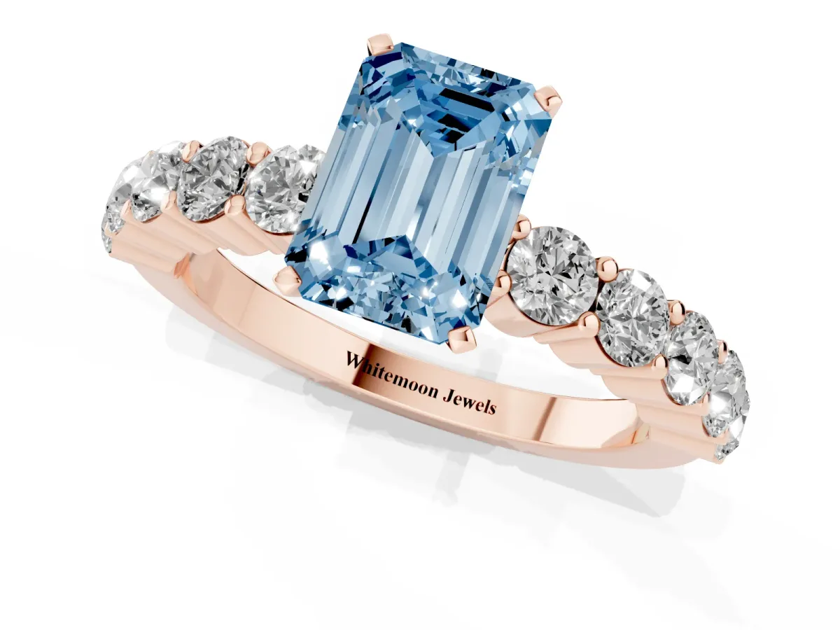 Fancy Blue Emerald Cut Diamond Solitaire Ring with Shared Prong Round Side Stones Rose gold