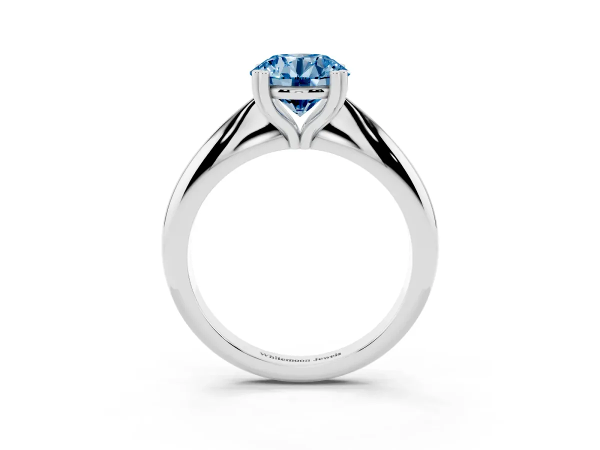 Fancy Blue Round Cut Cut Solitaire Engagement Ring with Tapered Band and Four-Prong Setting Silver