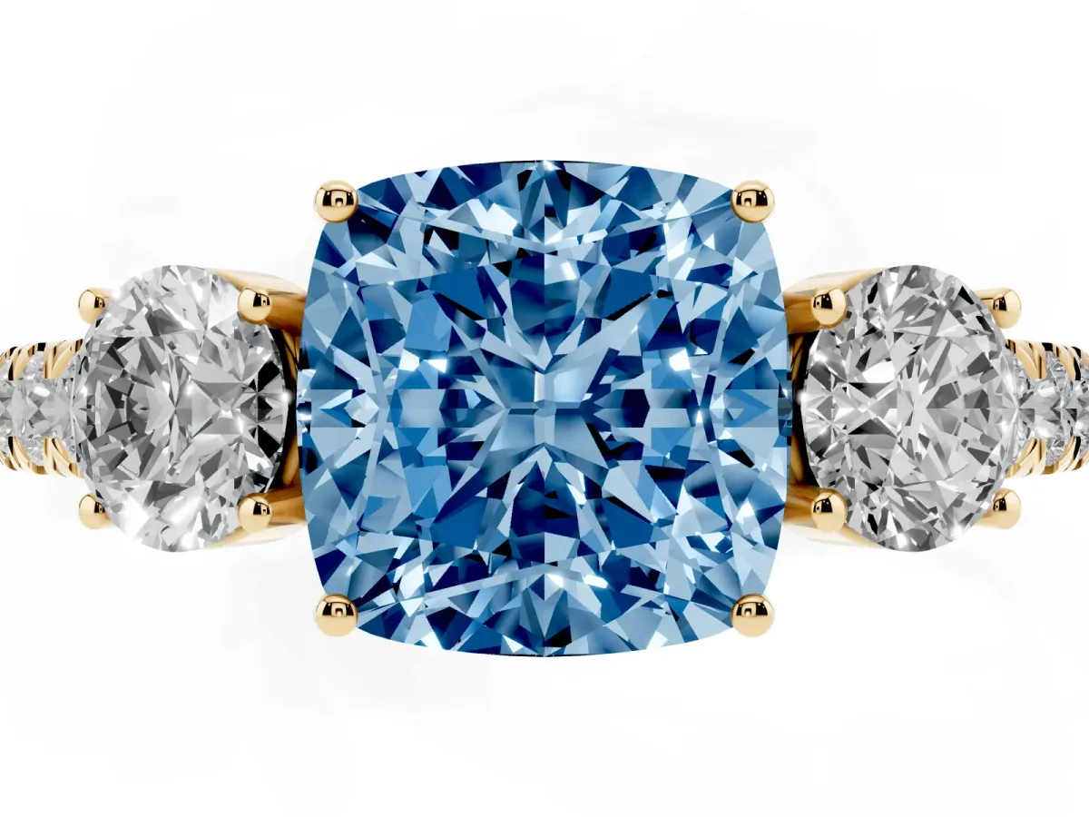Fancy Blue Cushion Cut Cut Diamond Three-Stone Ring with Round Side Stones and Pavé Band Yellow gold