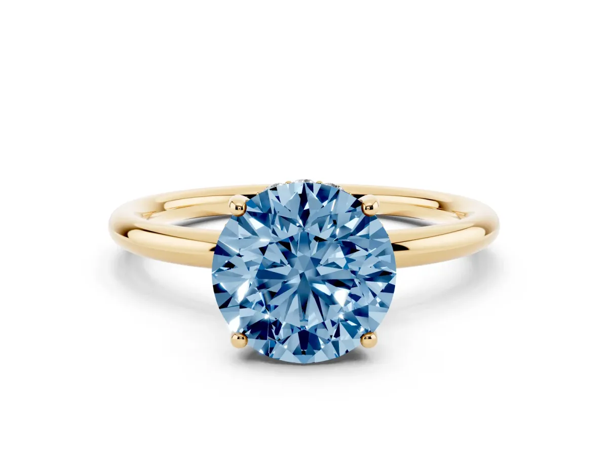 Fancy Blue Round Cut Solitaire Diamond Ring with a Classic Band and Four-Prong Setting Yellow gold
