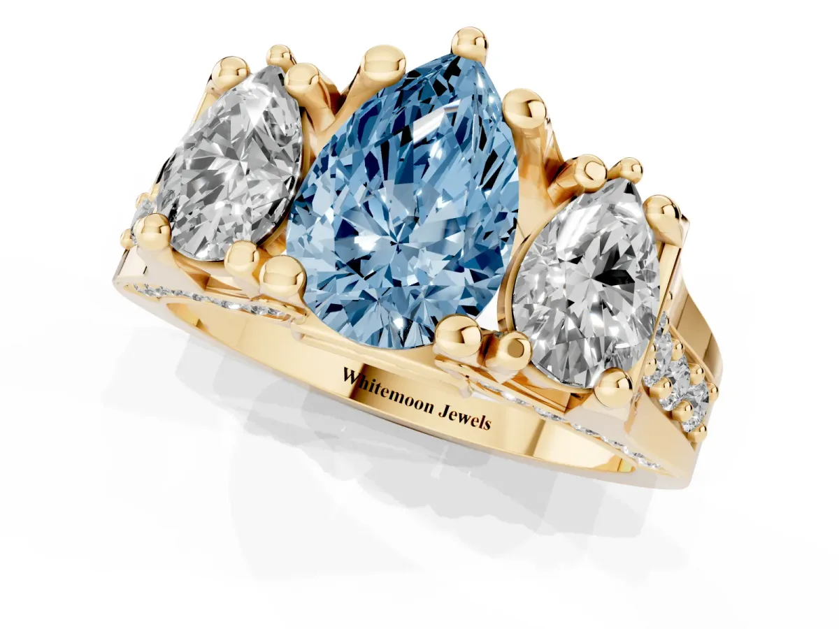 Fancy Blue Pear Cut Diamond Three-Stone Ring with Channel Set Band and Four-Prong Setting Yellow gold