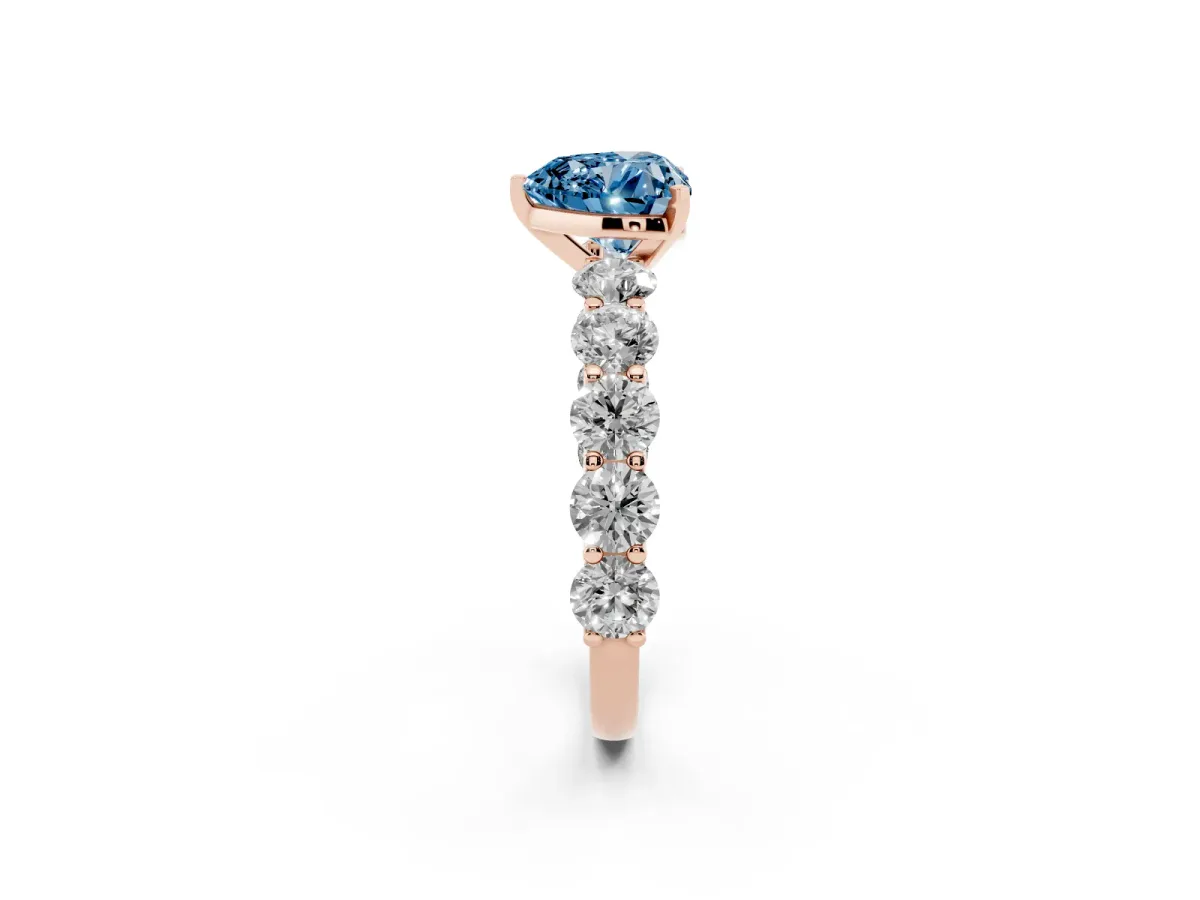 Fancy Blue Heart Cut Diamond Prong Setting with Side Stones on a Pave Band Rose gold