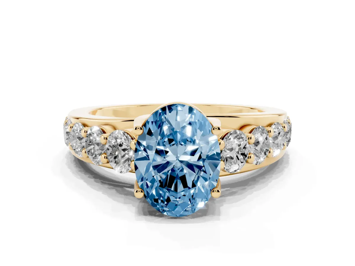 Fancy Blue Oval Cut Diamond Engagement Ring with Pavé Band and Four-Prong Setting Yellow gold