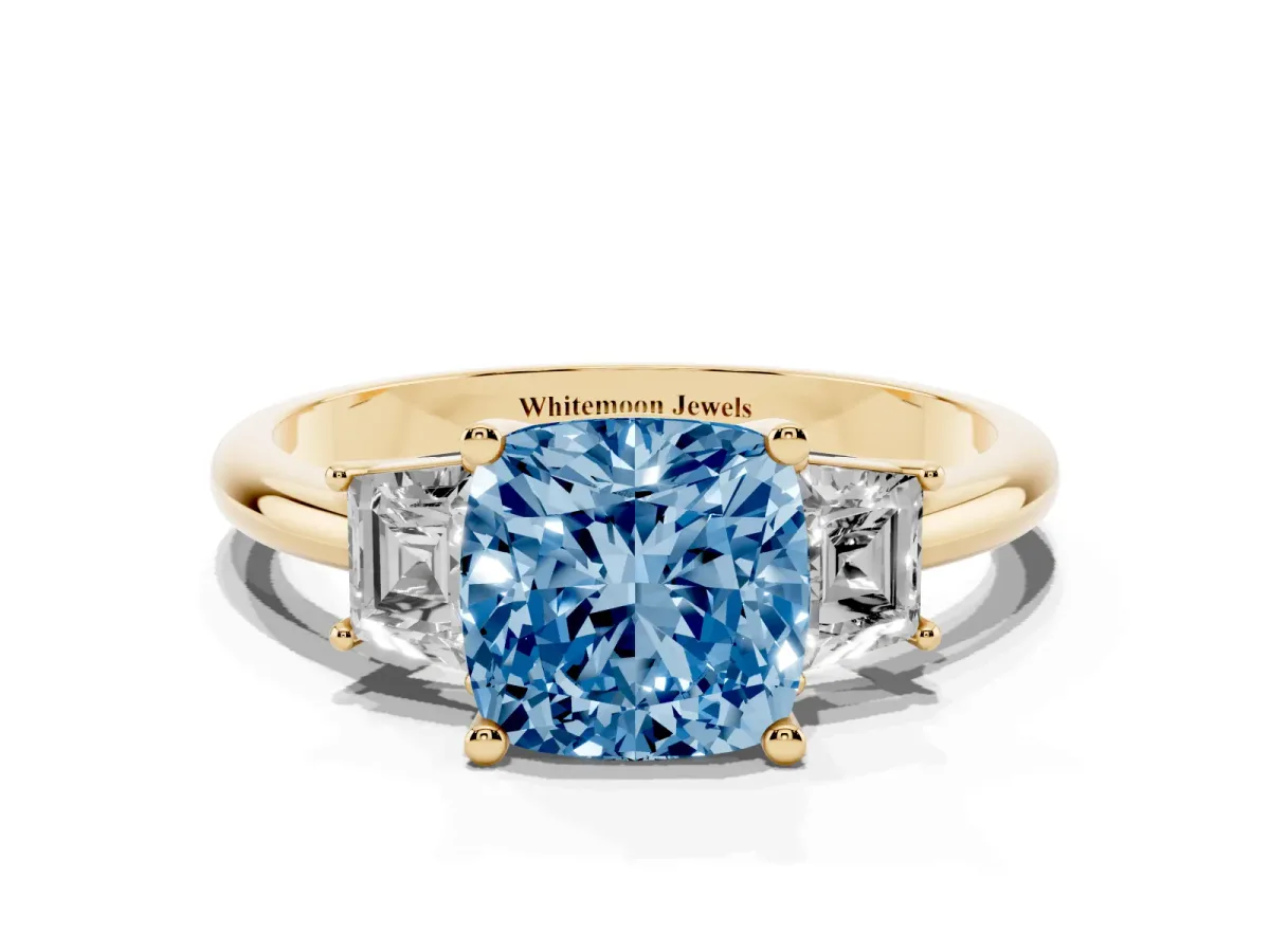 Fancy Blue Cushion Cut Diamond Three-Stone Ring with Trapezoid Side Stones and Prong Setting Yellow gold