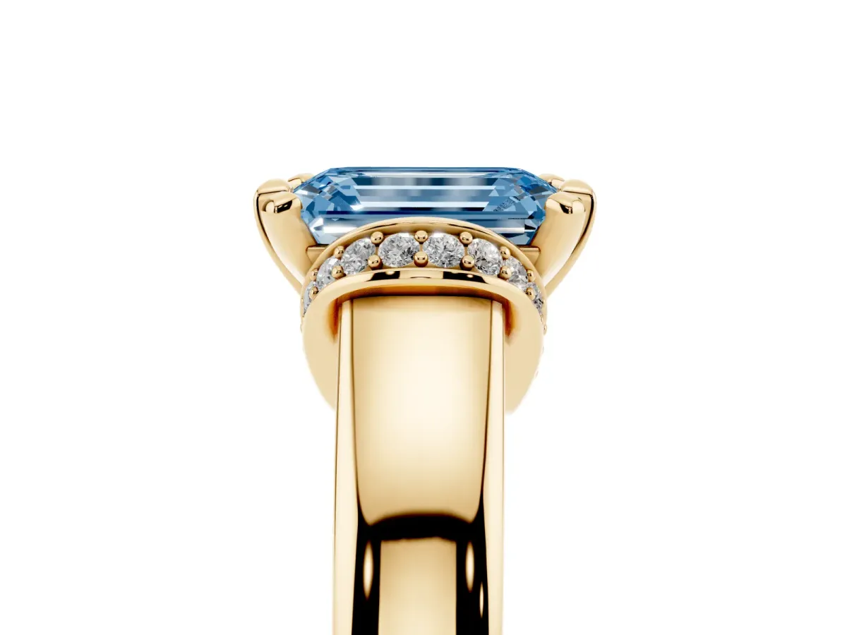 Fancy Blue Emerald Cut Solitaire Diamond Ring with Pave Band and Six-Prong Setting Yellow gold