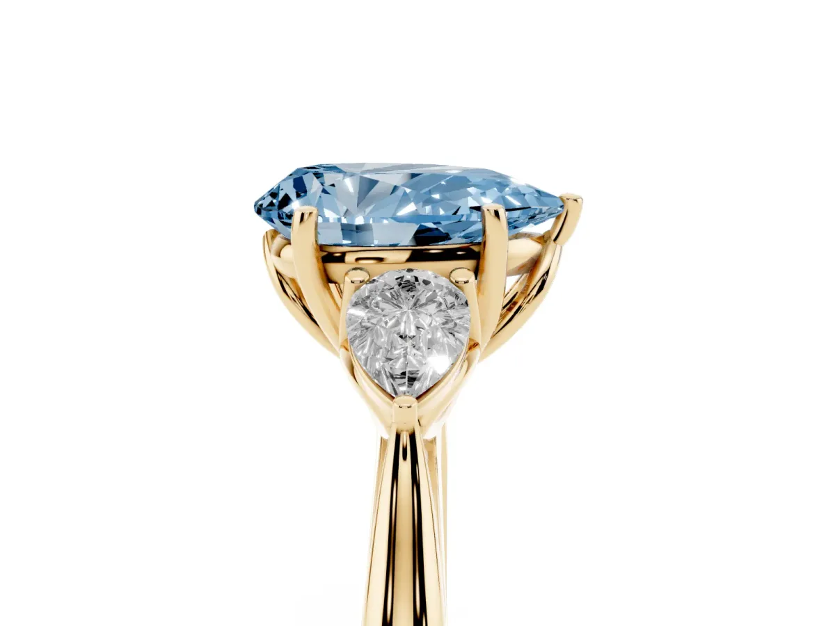 Fancy Blue Three-Stone Pear Cut Brilliant Diamond Solitaire Ring with Tapered Band and Four-Prong Setting Yellow gold