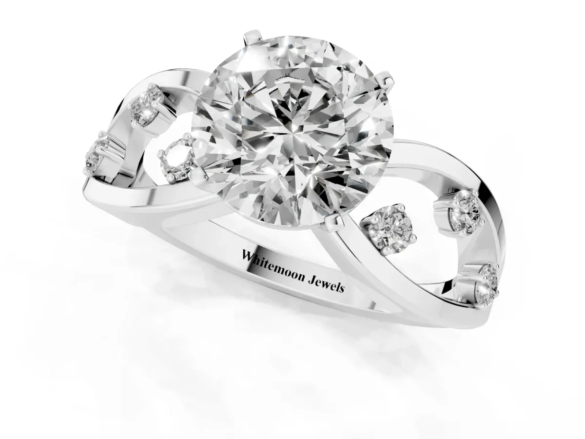 Round Cut Cut Solitaire Diamond with Side Stones on Criss-Cross Band and Four-Prong Setting Silver